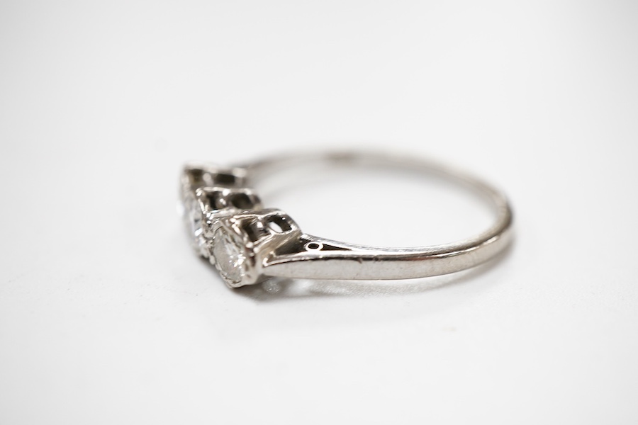 A three-stone diamond ring, set with three brilliant-cut diamonds totalling approximately 0.50 carats, mounted in platinum, size R1/2, British hallmarks, gross weight approximately 4 grams